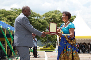 Speaker of Parliament, Donatille Mukabalisa, presents an award to one of the winners - Kigali, 02 November 2013